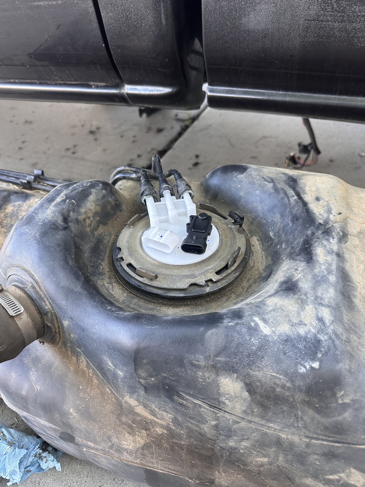 New fuel pump seated in the dropped fuel tank underneath a pickup